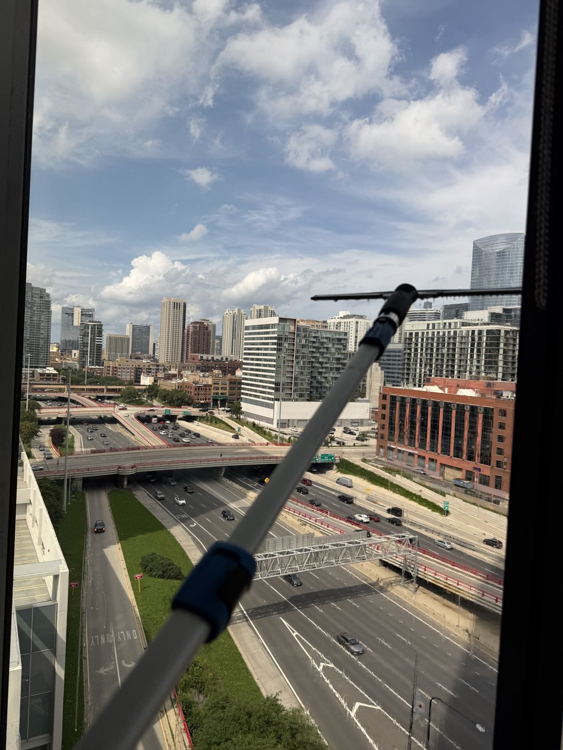 Clean Pushers crew cleaning interior glass in a Chicago Loop high-rise with skyline behind