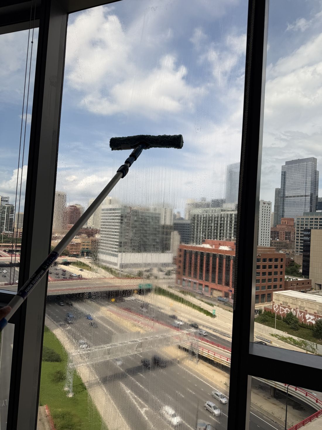 Clean Pushers cleaning interior glass in a downtown Chicago high-rise